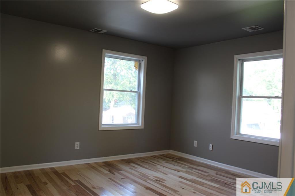 15 Kenmore Road Edison, NJ 08817 - Photo 23 of 35 a view of an empty room with wooden floor and a window