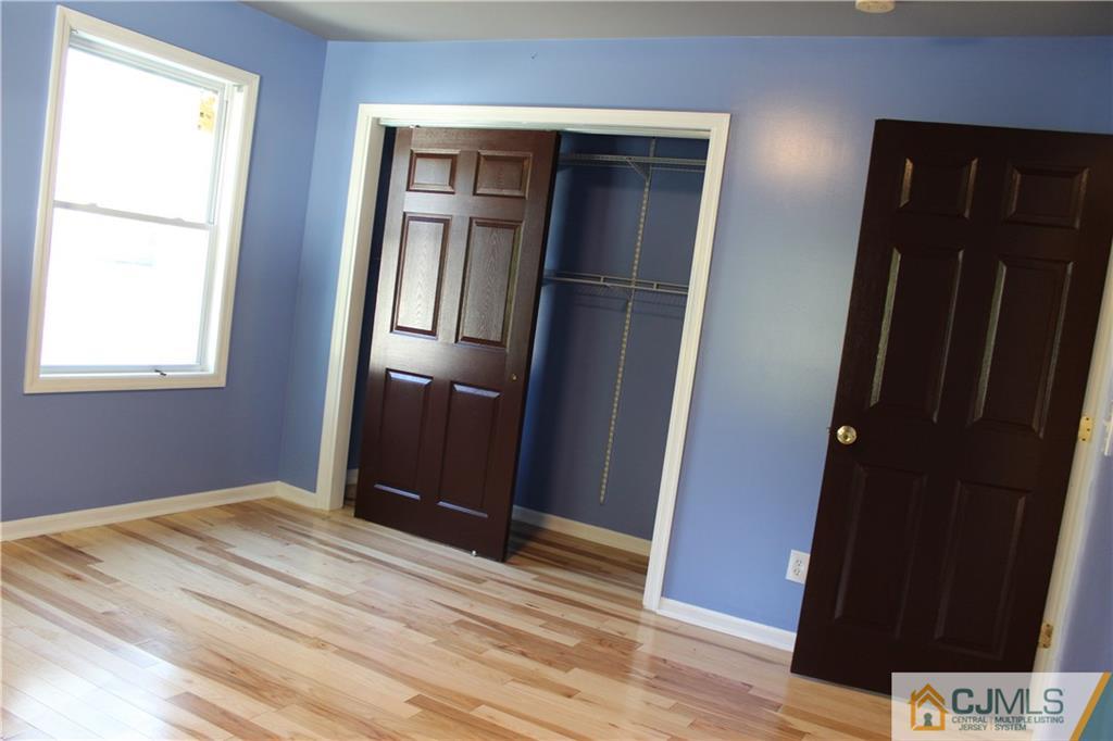15 Kenmore Road Edison, NJ 08817 - Photo 26 of 35 a view of empty room with wooden floor and closet
