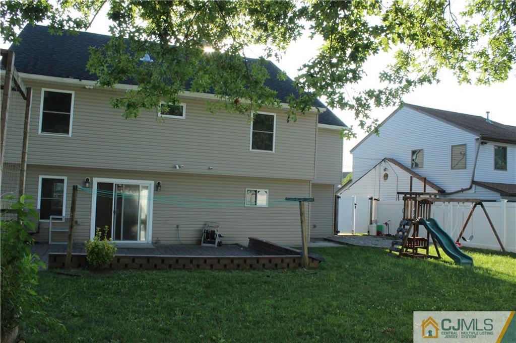 15 Kenmore Road Edison, NJ 08817 - Photo 34 of 35 a view of a house with a yard potted plants and a large tree