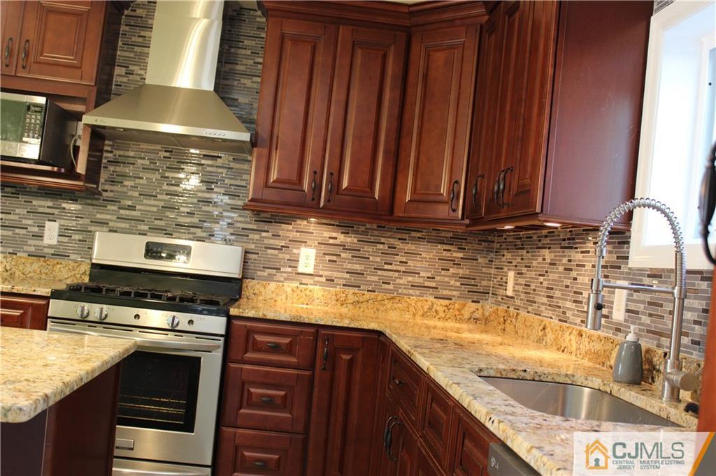 15 Kenmore Road Edison, NJ 08817 - Photo 10 of 35 a kitchen with granite countertop cabinets stainless steel appliances and a counter space