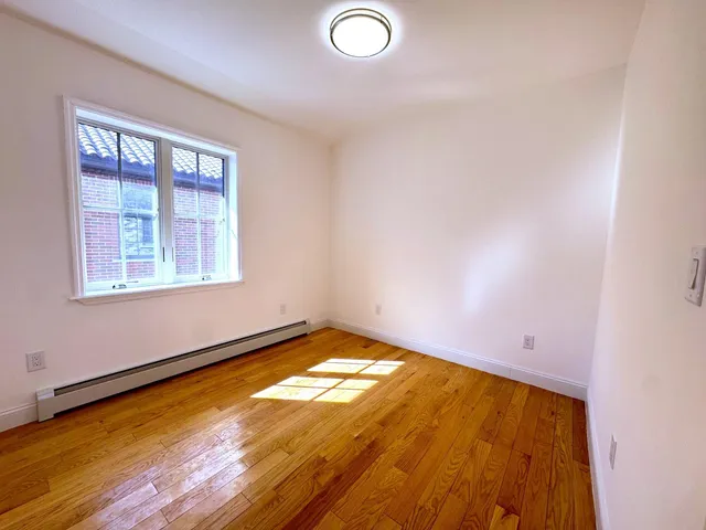 a view of a room with window and wooden floor