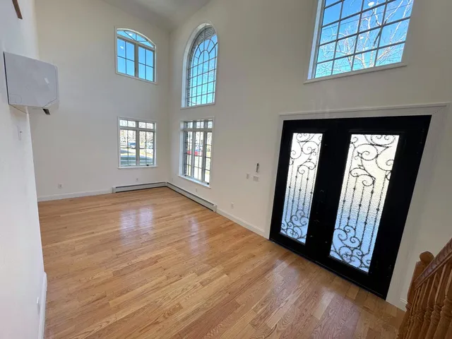 a view of front door with hallway and windows