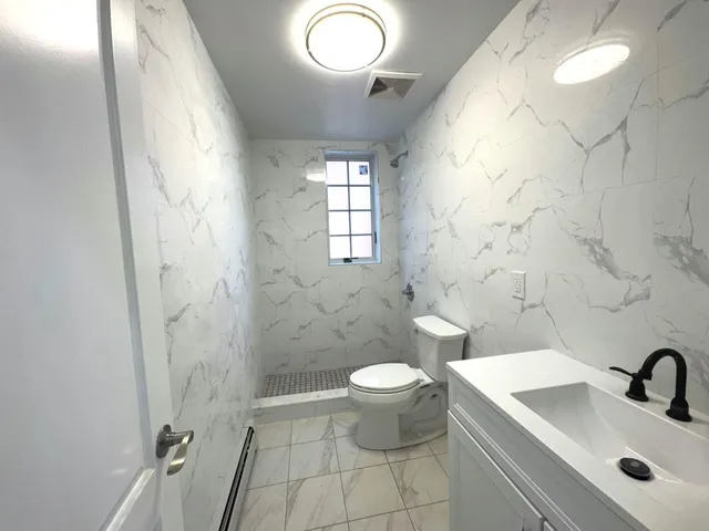 a bathroom with a sink toilet and shower