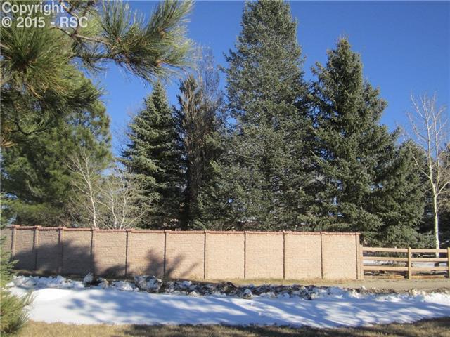 23455 Murphy Road Calhan, CO 80808 - Photo 3 of 5 Concrete privacy and split rail fence surrounding yard
