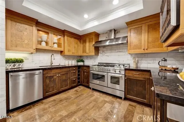 a kitchen with stainless steel appliances granite countertop a stove and a sink