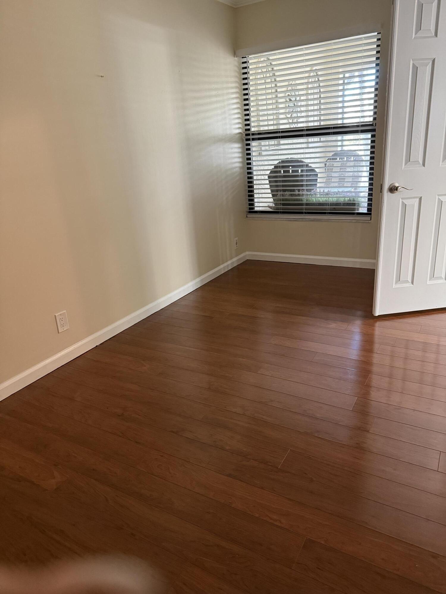 21583 Villa Nova Drive Boca Raton, FL 33433 - Photo 12 of 33 an empty room with wooden floor and windows