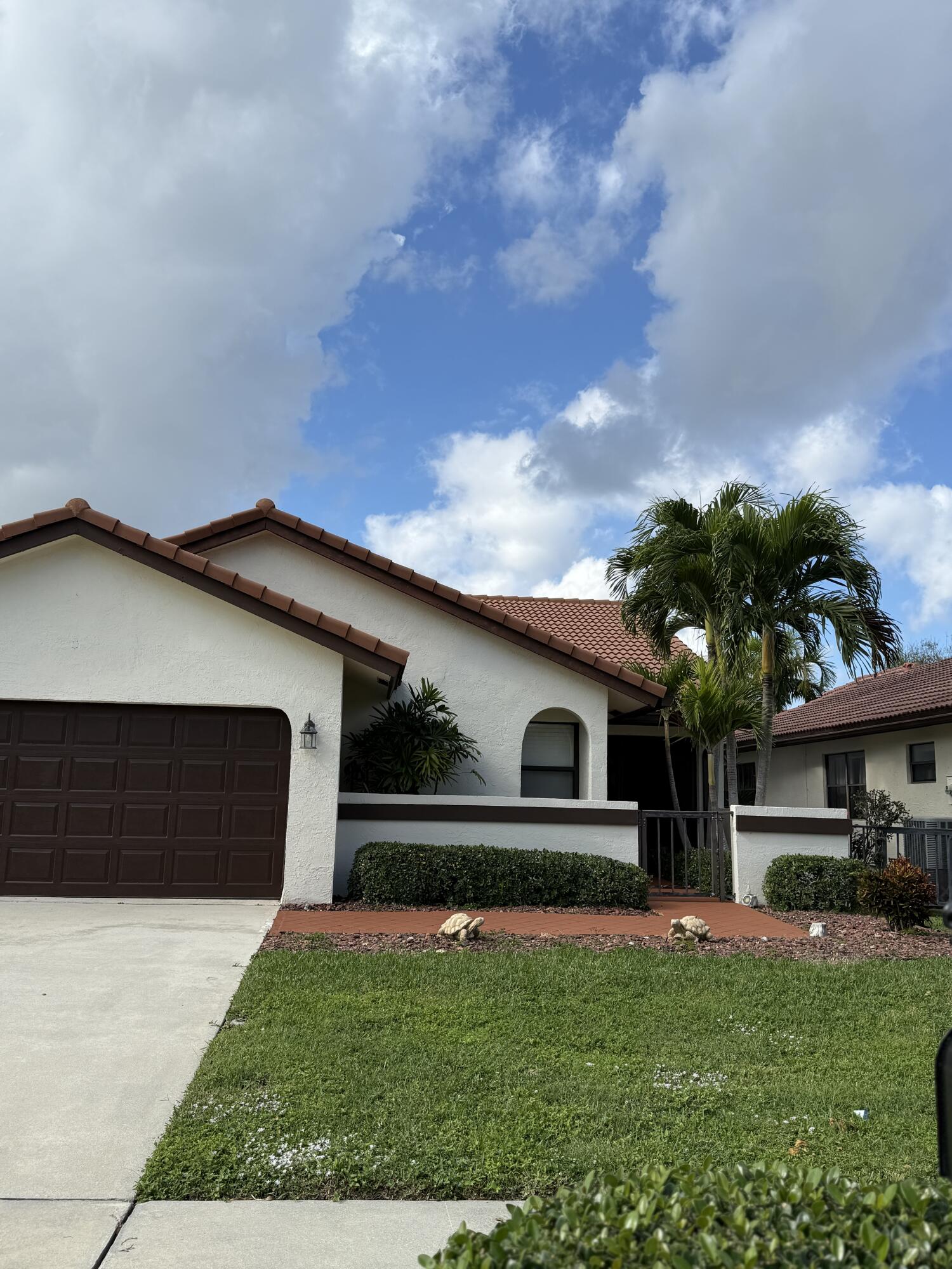 21583 Villa Nova Drive Boca Raton, FL 33433 - Photo 2 of 33 a front view of a house with a garden and yard