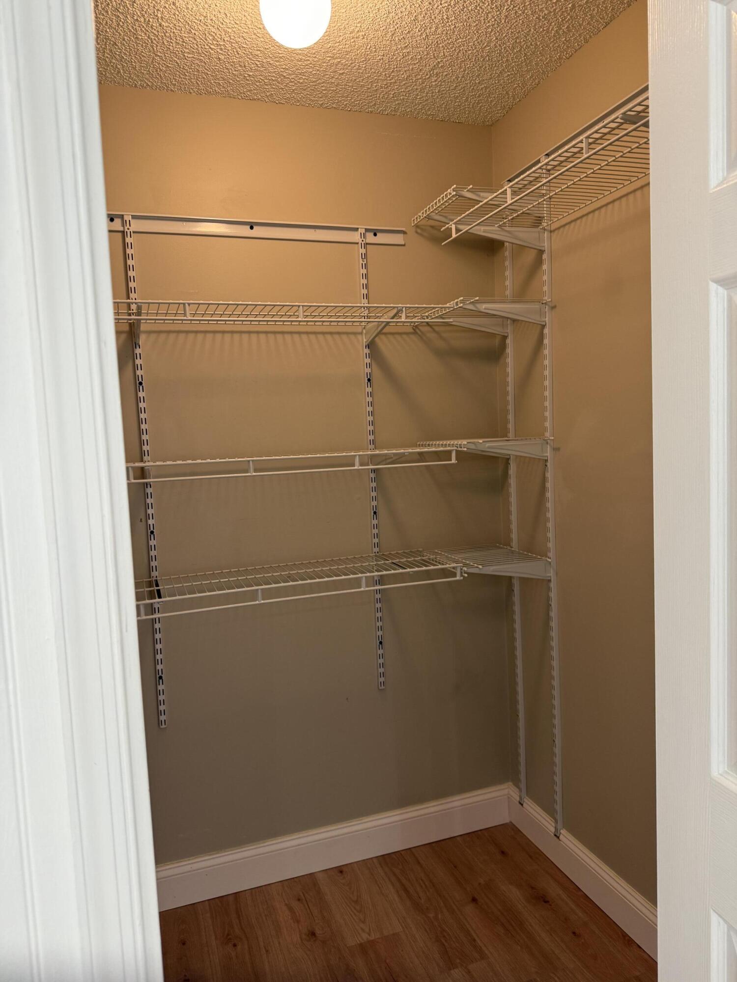 21583 Villa Nova Drive Boca Raton, FL 33433 - Photo 26 of 33 a view of a room with wooden floor