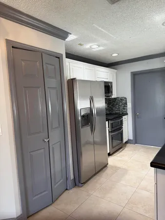 a kitchen with stainless steel appliances a refrigerator and a sink