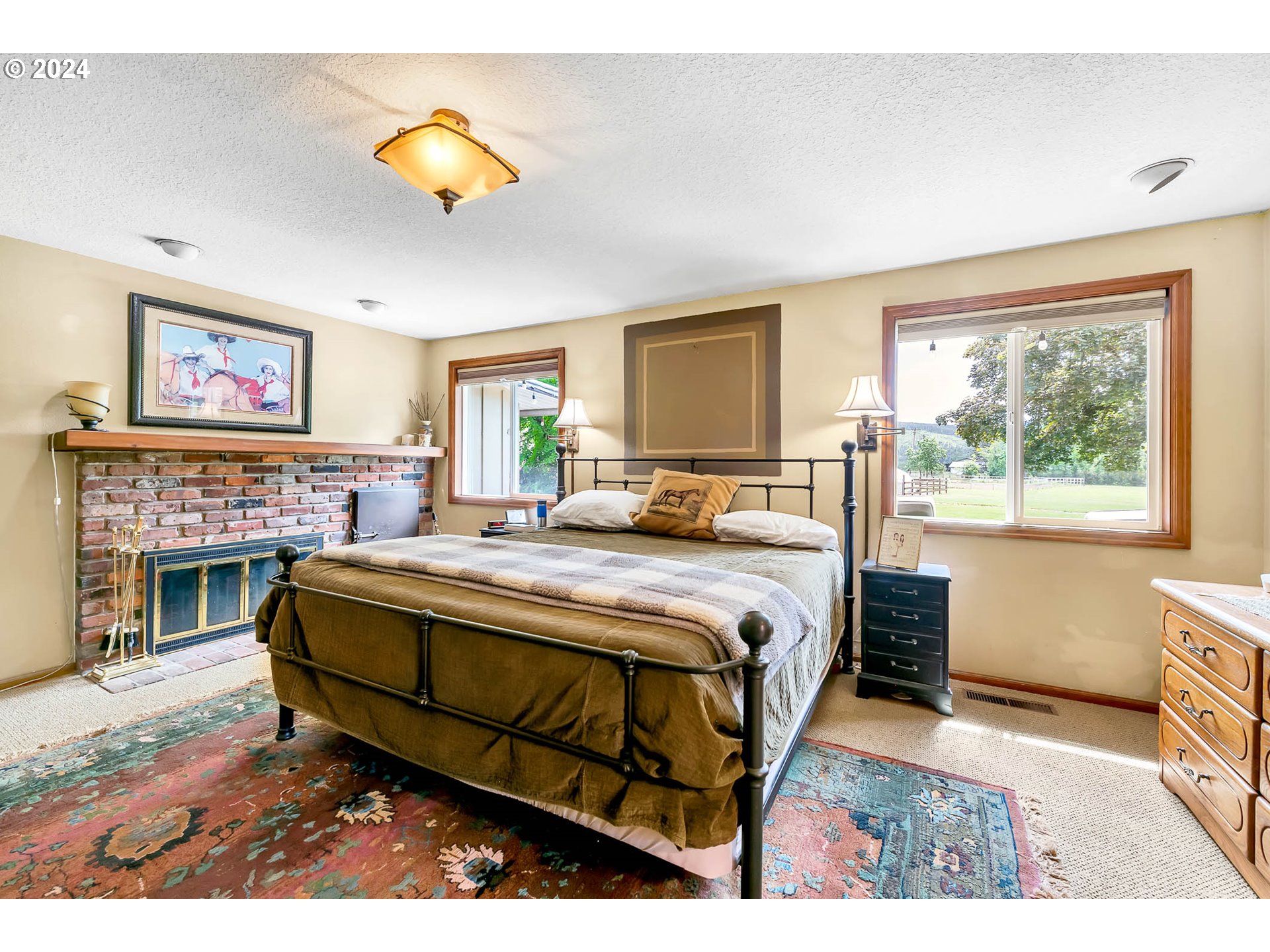 91281 Donna Road Springfield, OR 97478 - Photo 21 of 42 a bedroom with a bed and a fireplace