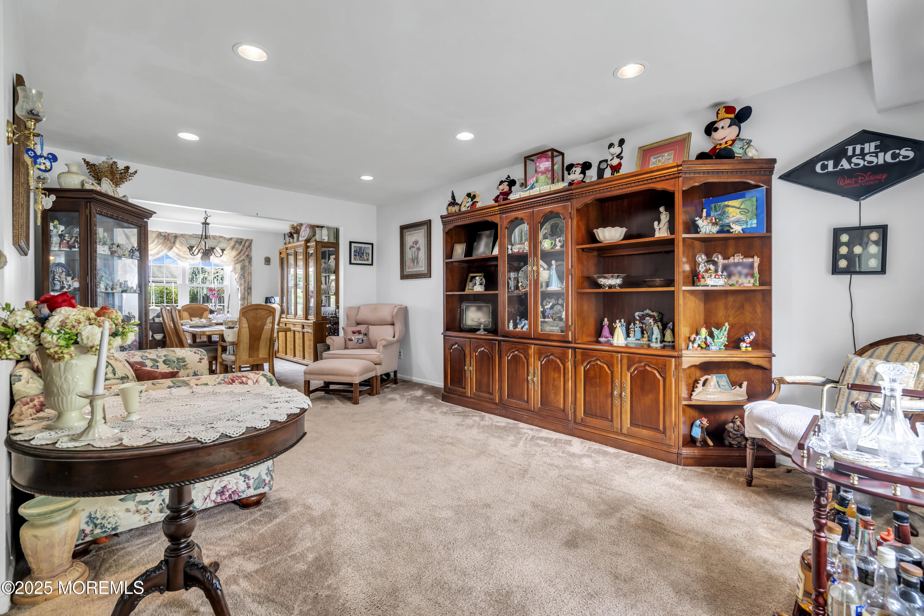 9 Yellowstone Lane Howell, NJ 07731 - Photo 12 of 37 a living room with furniture gym equipment and a chandelier