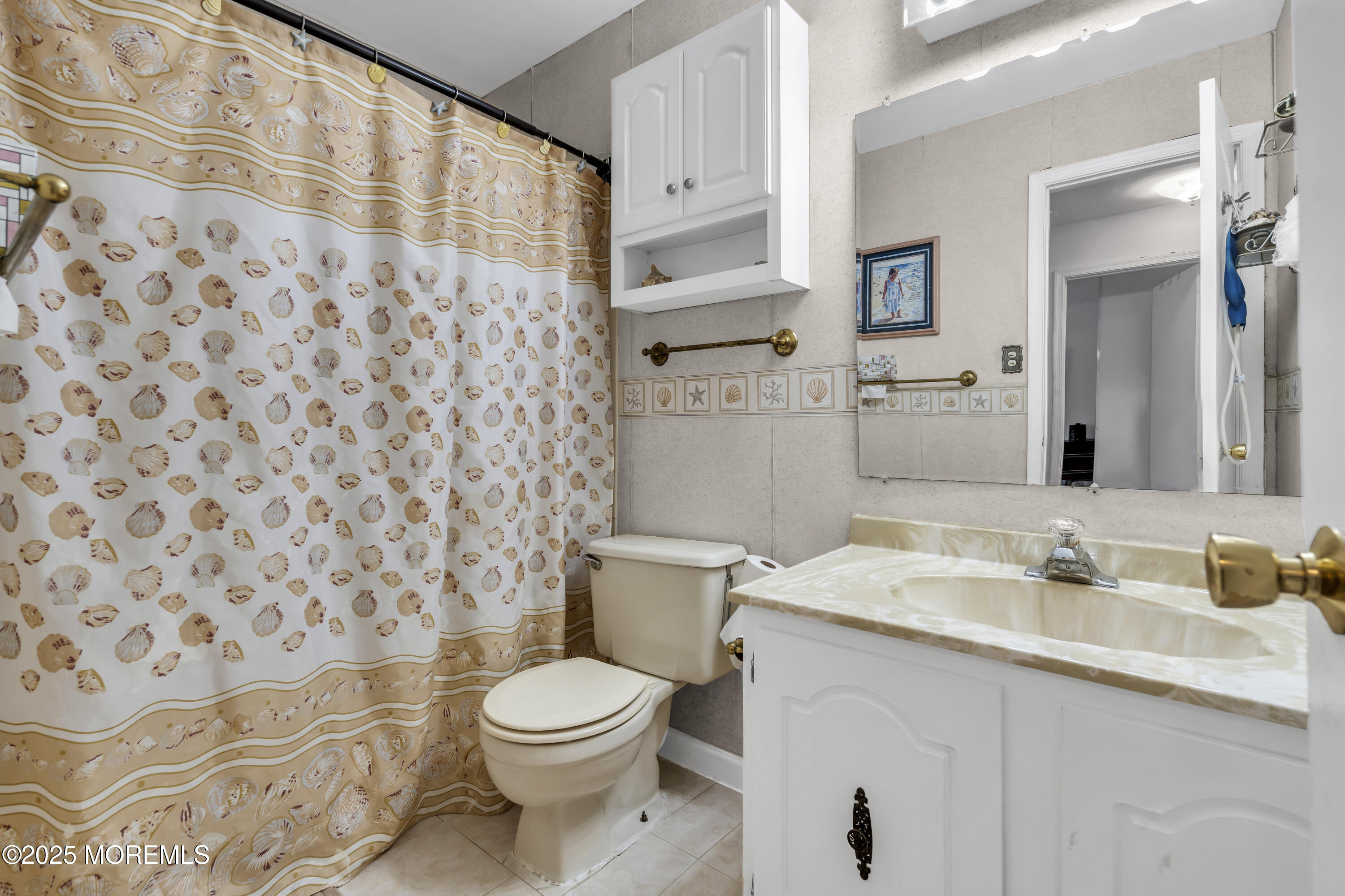 9 Yellowstone Lane Howell, NJ 07731 - Photo 30 of 37 a bathroom with a sink a toilet and shower curtain