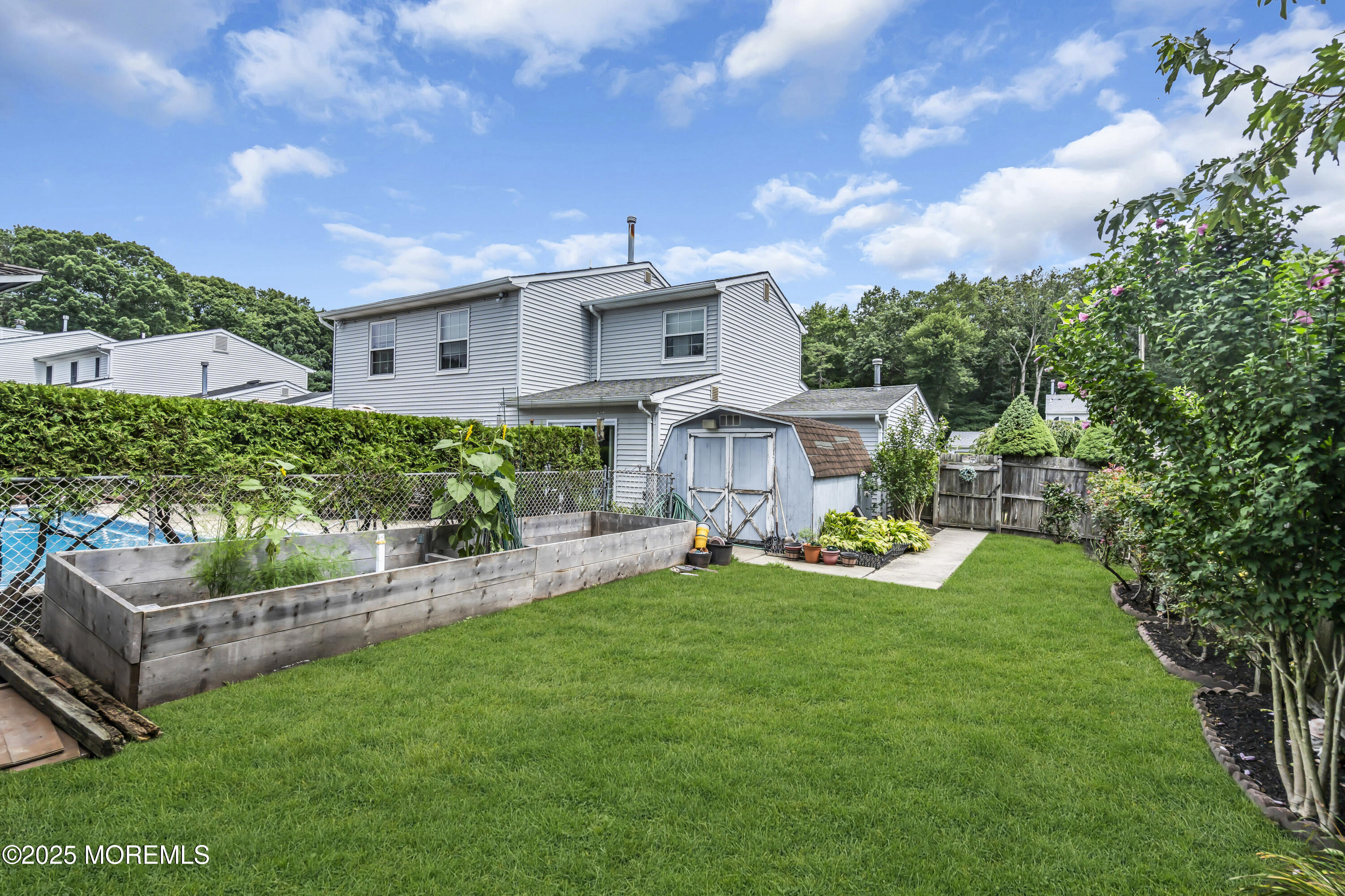 9 Yellowstone Lane Howell, NJ 07731 - Photo 33 of 37 a view of a house with a backyard and a patio