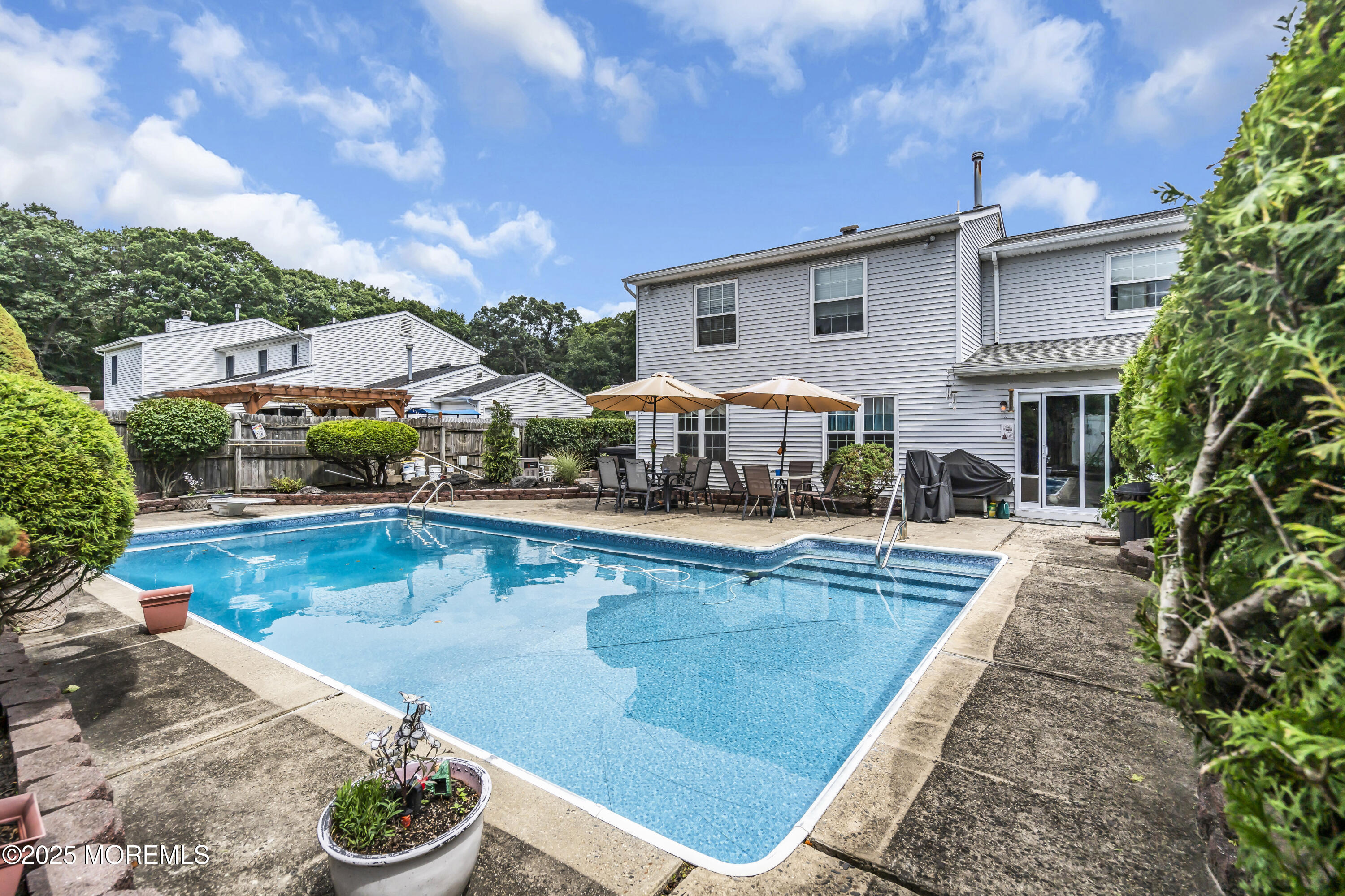 9 Yellowstone Lane Howell, NJ 07731 - Photo 35 of 37 a view of a swimming pool with sitting area