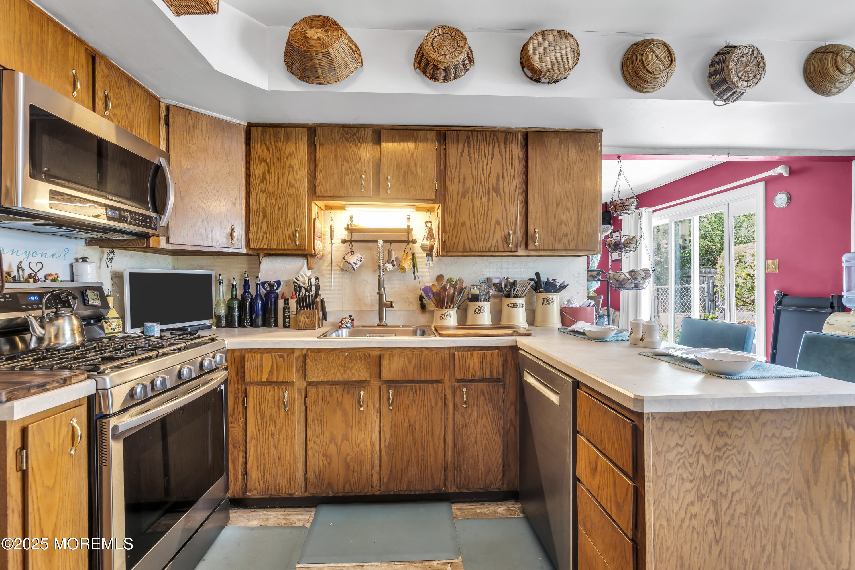 9 Yellowstone Lane Howell, NJ 07731 - Photo 8 of 37 a kitchen with stainless steel appliances a stove a sink and a microwave