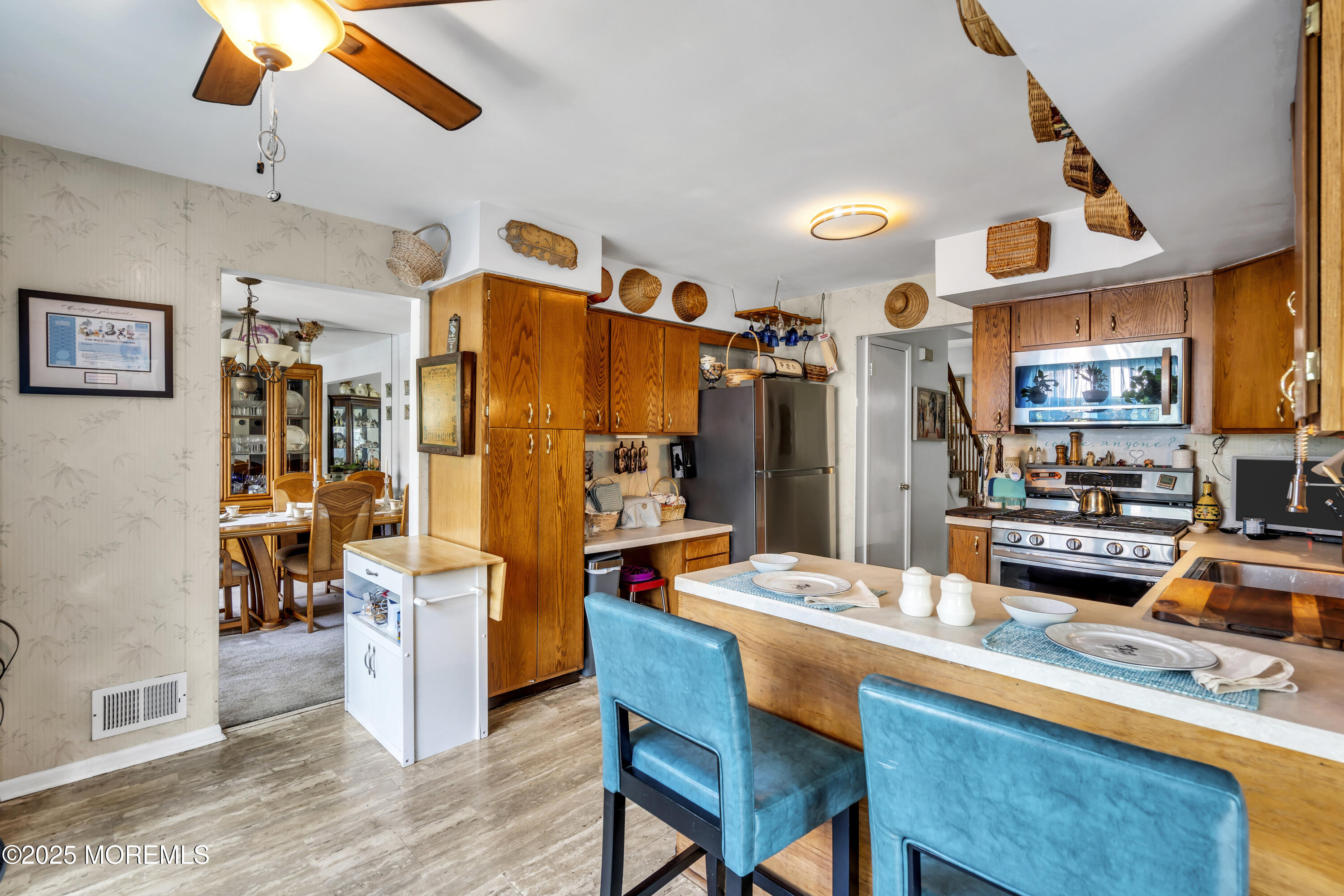 9 Yellowstone Lane Howell, NJ 07731 - Photo 9 of 37 a dining hall with stainless steel appliances kitchen island granite countertop a dining table and chairs