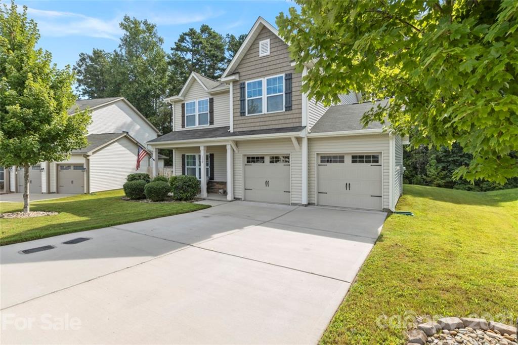 112 Tranquil Court Locust, NC 28097 - Photo 2 of 25 a front view of a house with garden
