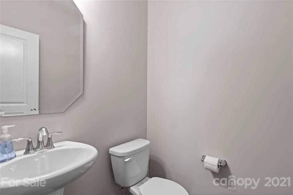 112 Tranquil Court Locust, NC 28097 - Photo 12 of 25 a bathroom with a toilet a sink and mirror