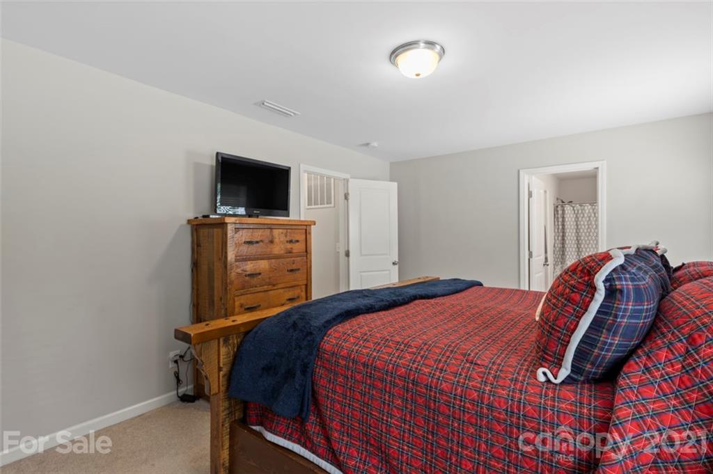 112 Tranquil Court Locust, NC 28097 - Photo 17 of 25 a bedroom with a bed and a television