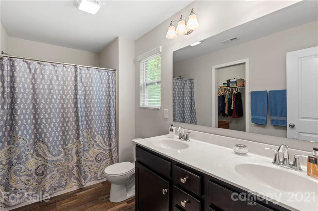 112 Tranquil Court Locust, NC 28097 - Photo 18 of 25 a bathroom with a double vanity sink toilet and a mirror