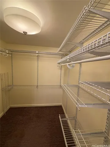 a white toilet sitting next to a bathroom sink and vanity
