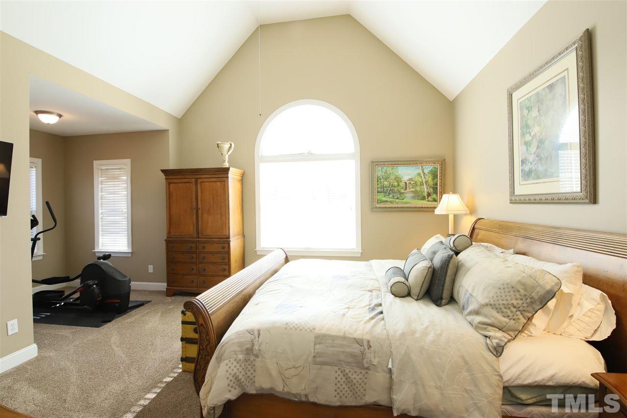 844 Oxen Circle Raleigh, NC 27603 - Photo 11 of 30 a bedroom with a bed and wooden floor