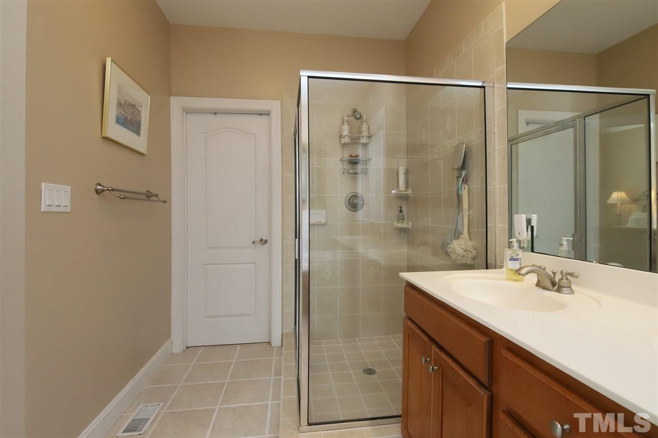 844 Oxen Circle Raleigh, NC 27603 - Photo 13 of 30 a bathroom with a shower sink and mirror