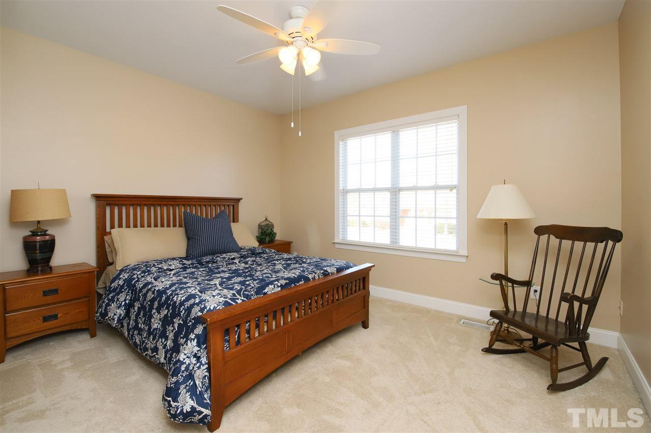 844 Oxen Circle Raleigh, NC 27603 - Photo 15 of 30 a bedroom with a bed chair and window