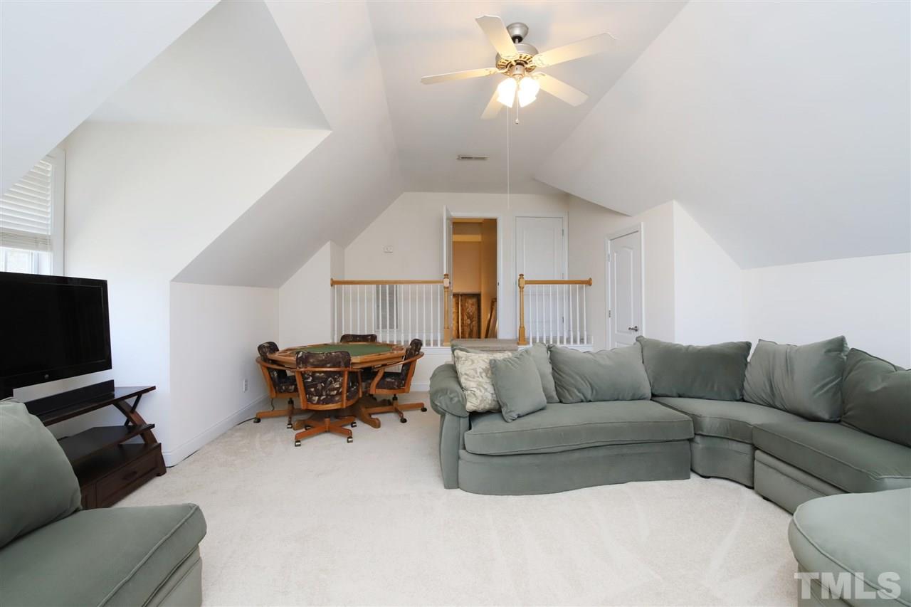 844 Oxen Circle Raleigh, NC 27603 - Photo 17 of 30 a living room with furniture a couch and a flat screen tv