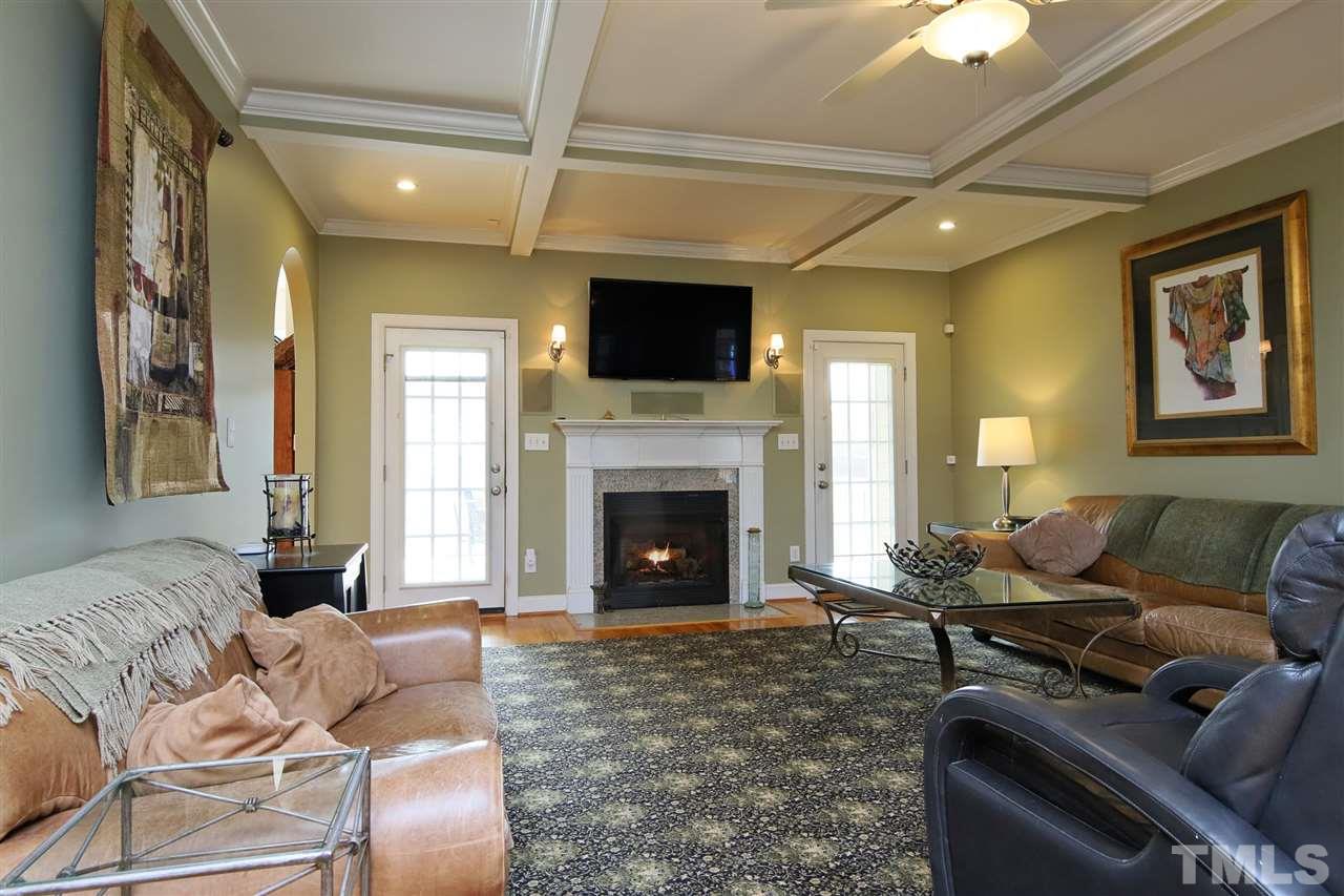 844 Oxen Circle Raleigh, NC 27603 - Photo 5 of 30 a living room with furniture a flat screen tv and a fireplace