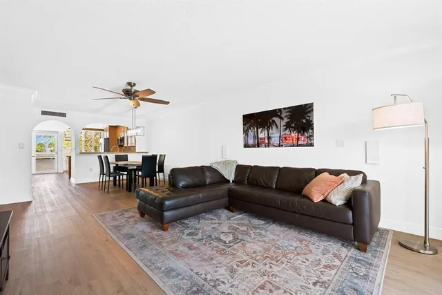 a living room with furniture and wooden floor
