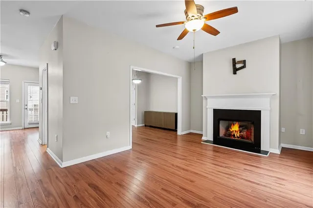 a view of a livingroom with wooden floor and a fireplace