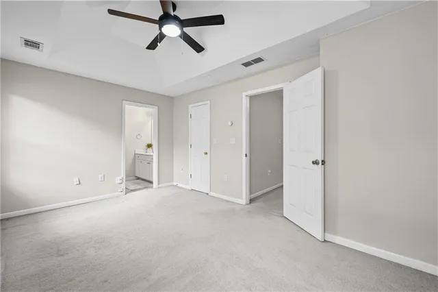 an empty room with chandelier fan