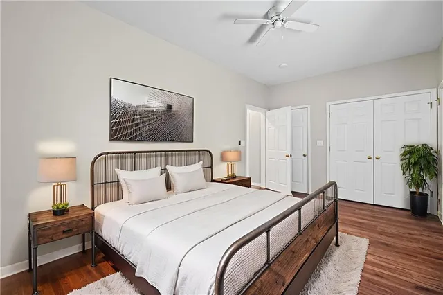 a bedroom with bed and paintings on the wall