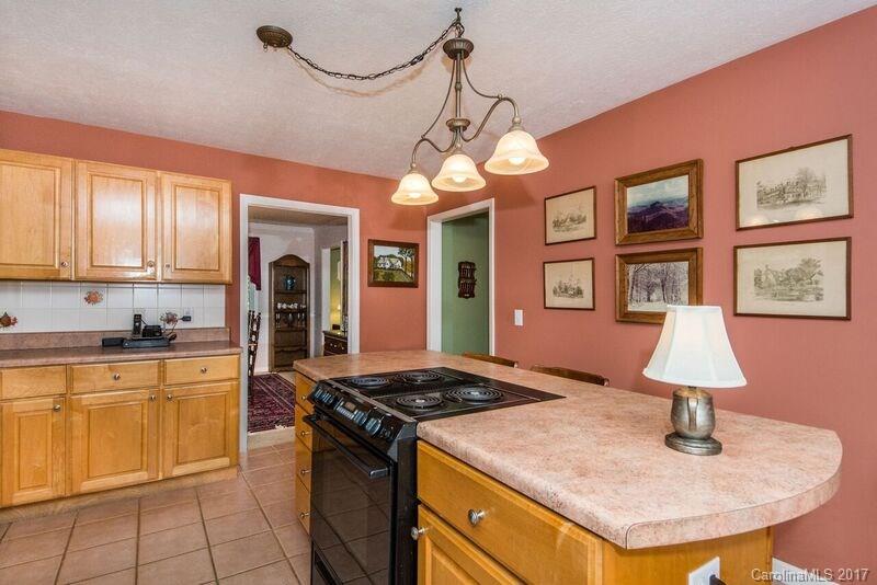 501 Oak Ridge Drive Clyde, NC 28721 - Photo 11 of 24 a kitchen with stainless steel appliances granite countertop a sink a stove and a refrigerator