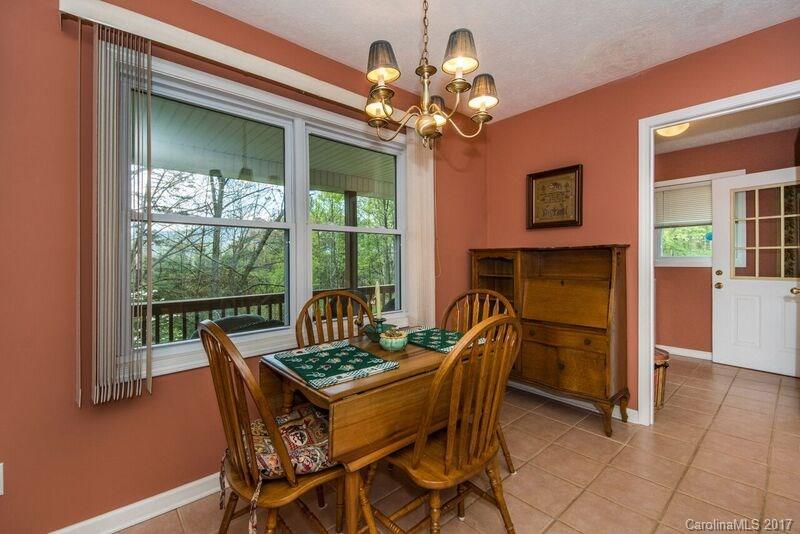 501 Oak Ridge Drive Clyde, NC 28721 - Photo 12 of 24 a dining room with furniture and a floor to ceiling window