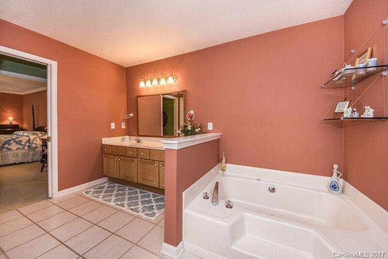 501 Oak Ridge Drive Clyde, NC 28721 - Photo 15 of 24 a bathroom with a sink a mirror and a bathtub