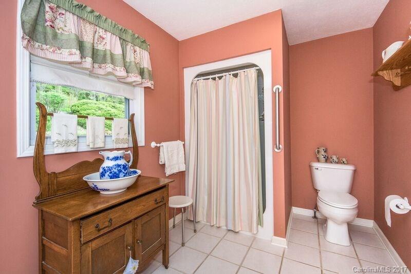 501 Oak Ridge Drive Clyde, NC 28721 - Photo 16 of 24 a bathroom with a sink a toilet and a window