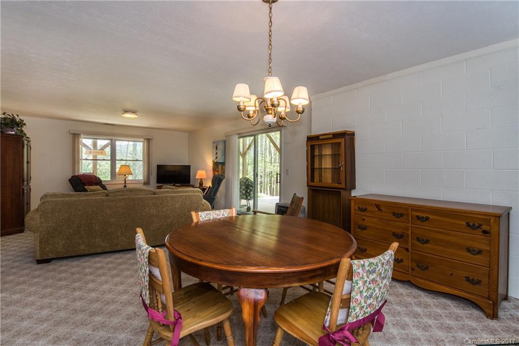 501 Oak Ridge Drive Clyde, NC 28721 - Photo 20 of 24 a view of a dining room with furniture and chandelier