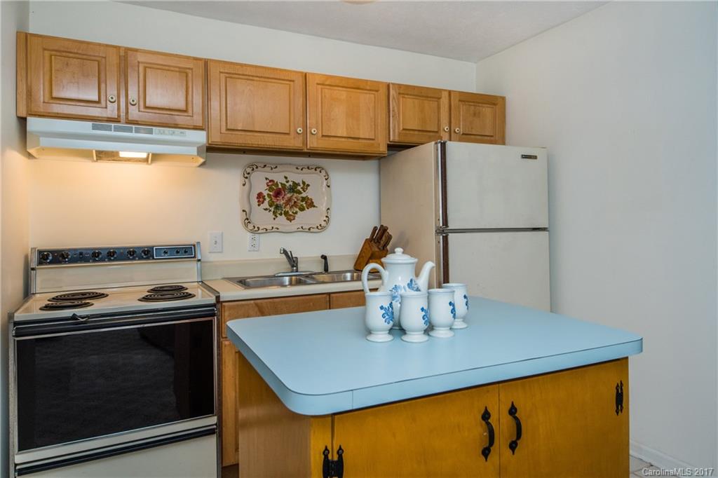 501 Oak Ridge Drive Clyde, NC 28721 - Photo 21 of 24 a kitchen with a sink a stove and cabinets