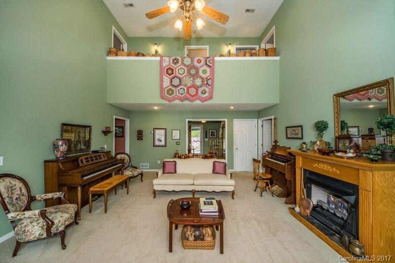 501 Oak Ridge Drive Clyde, NC 28721 - Photo 6 of 24 a living room with furniture and a fireplace