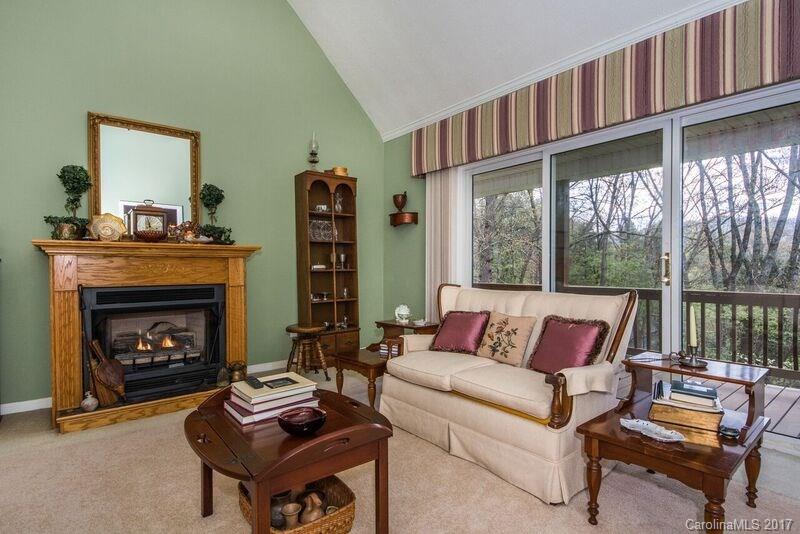 501 Oak Ridge Drive Clyde, NC 28721 - Photo 8 of 24 a living room with furniture a fireplace and a large window