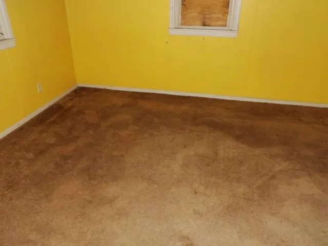 an empty room with a empty space and a window