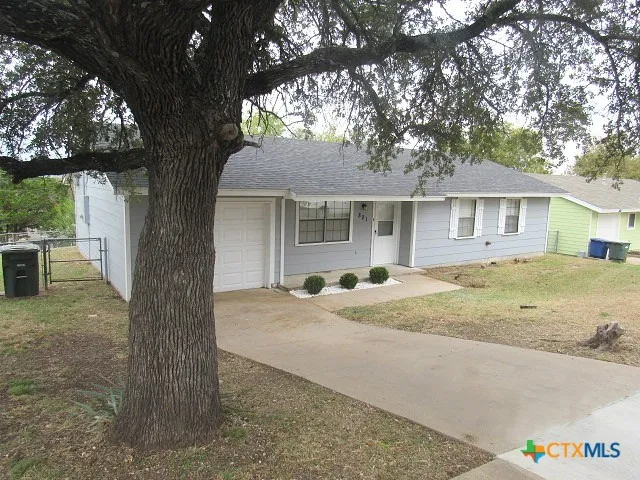 a view of a house with a tree in front