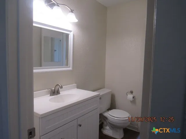 a bathroom with a toilet a sink and mirror