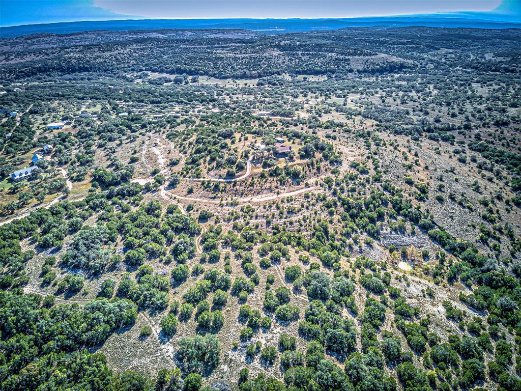 414 Hall Lane Spicewood, TX 78669 - Photo 2 of 16 an aerial view of a house with a yard and mountain view in back