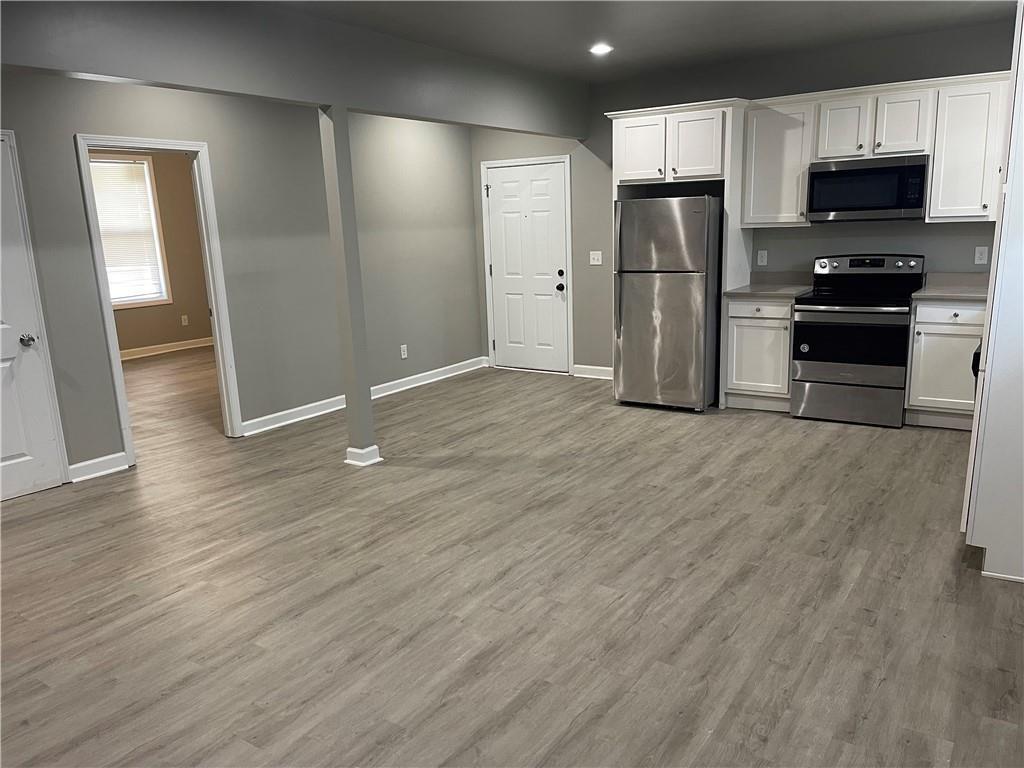 1155 Lucile Avenue Southwest, Unit 1 Atlanta, GA 30310 - Photo 4 of 10 a view of kitchen with stainless steel appliances wooden floor and cabinets