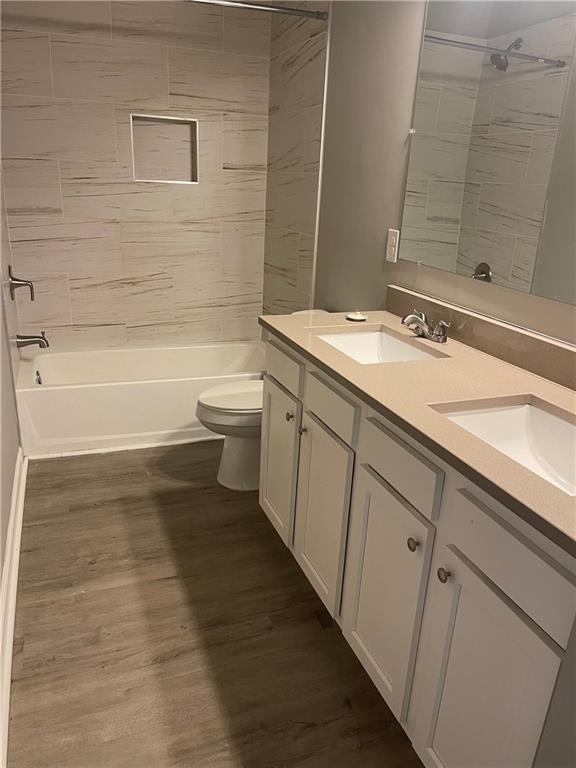 1155 Lucile Avenue Southwest, Unit 1 Atlanta, GA 30310 - Photo 6 of 10 a bathroom with a granite countertop sink a toilet and bathtub