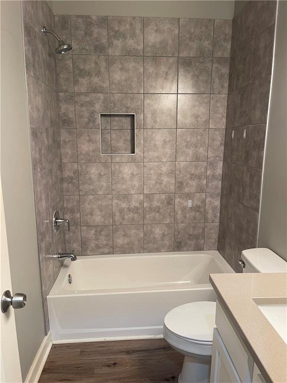 1155 Lucile Avenue Southwest, Unit 1 Atlanta, GA 30310 - Photo 9 of 10 a bathroom with a granite countertop bathtub toilet and sink
