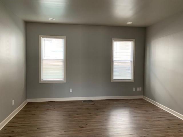 1155 Lucile Avenue Southwest, Unit 1 Atlanta, GA 30310 - Photo 10 of 10 a view of an empty room with wooden floor and a window